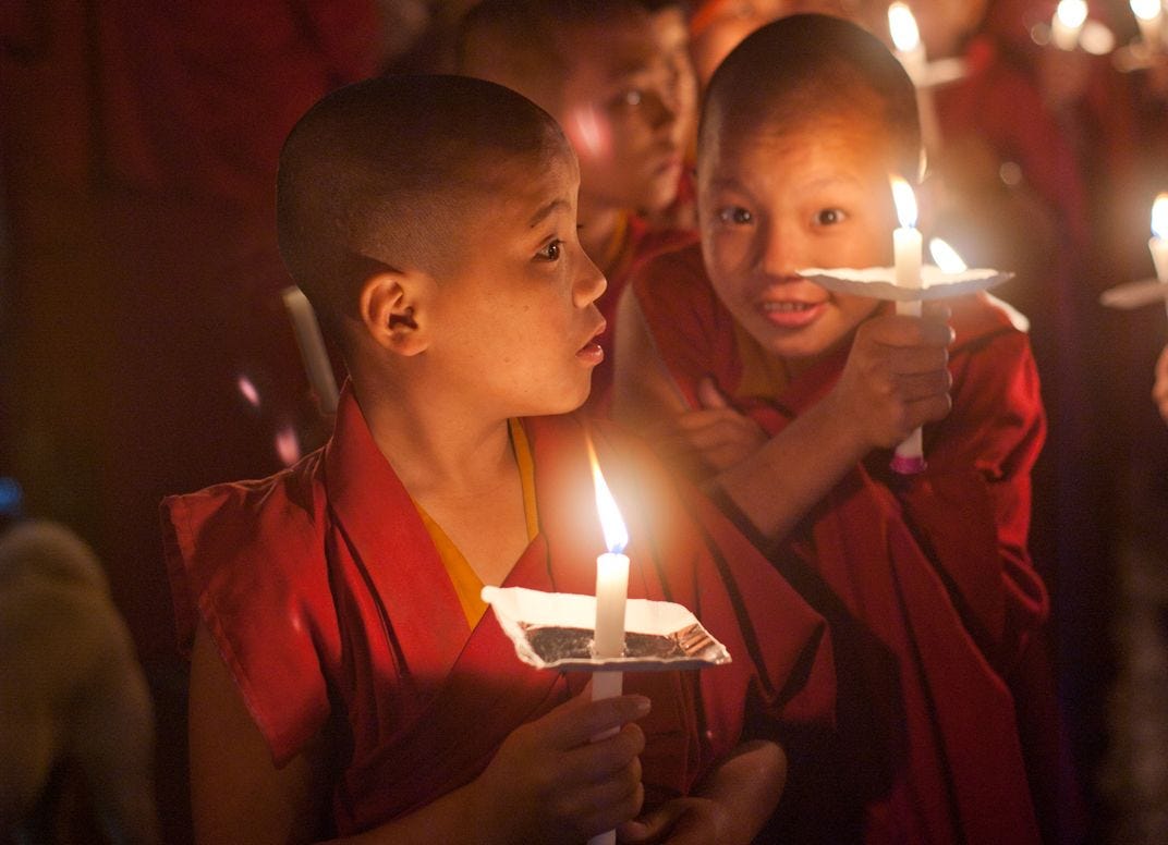 Little Tibetan Buddhist monks participate in a candle light procession ...