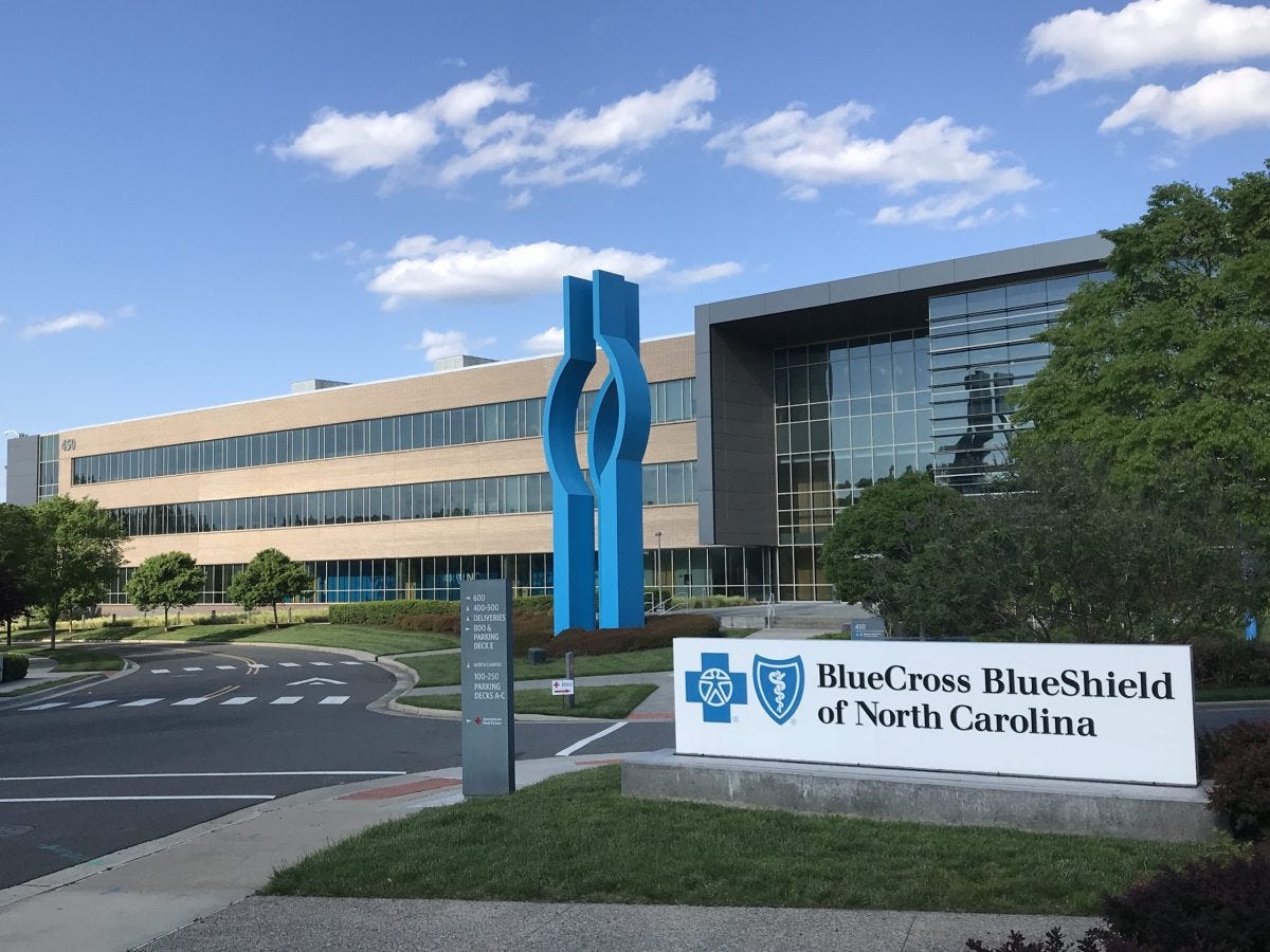 shows a building with a weird blue sculpture in front of it and a large sign reading Blue Cross Blue Shield of North Carolina