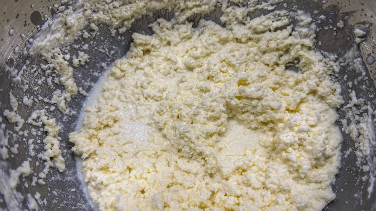 The inside of the mixing bowl, where butterfat has started separating from the buttermilk. The texture is somewhat similar to watery cottage cheese. 