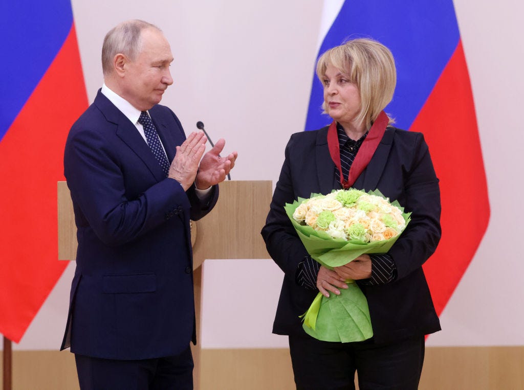 Russian President Vladimir Putin (L) greets Chairman of Central Election Commission Ella Pamfilova (R) during an awarding ceremony at the Novo-Ogaryovo State Residence, on November 15, 2023.