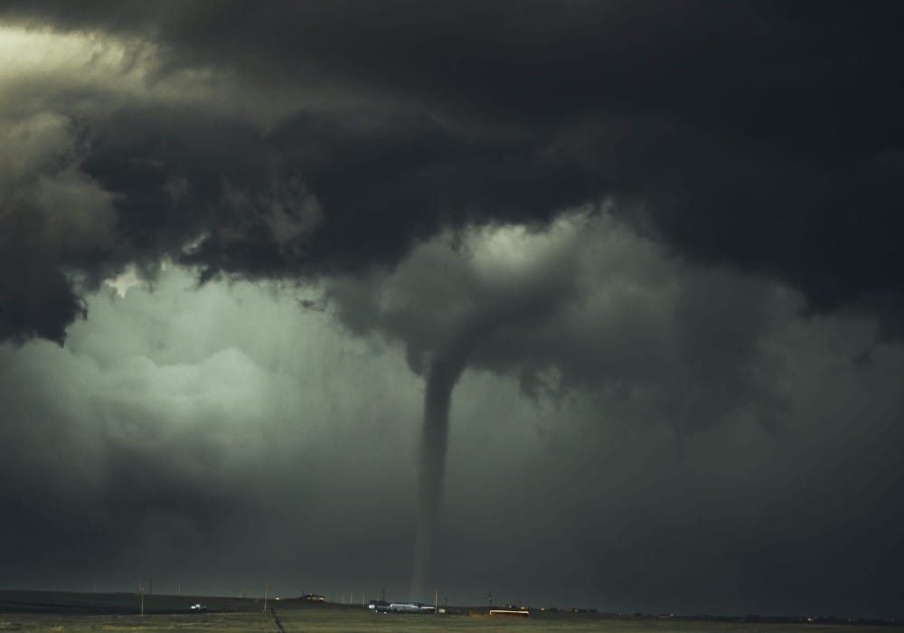 Tornado touching down in a field