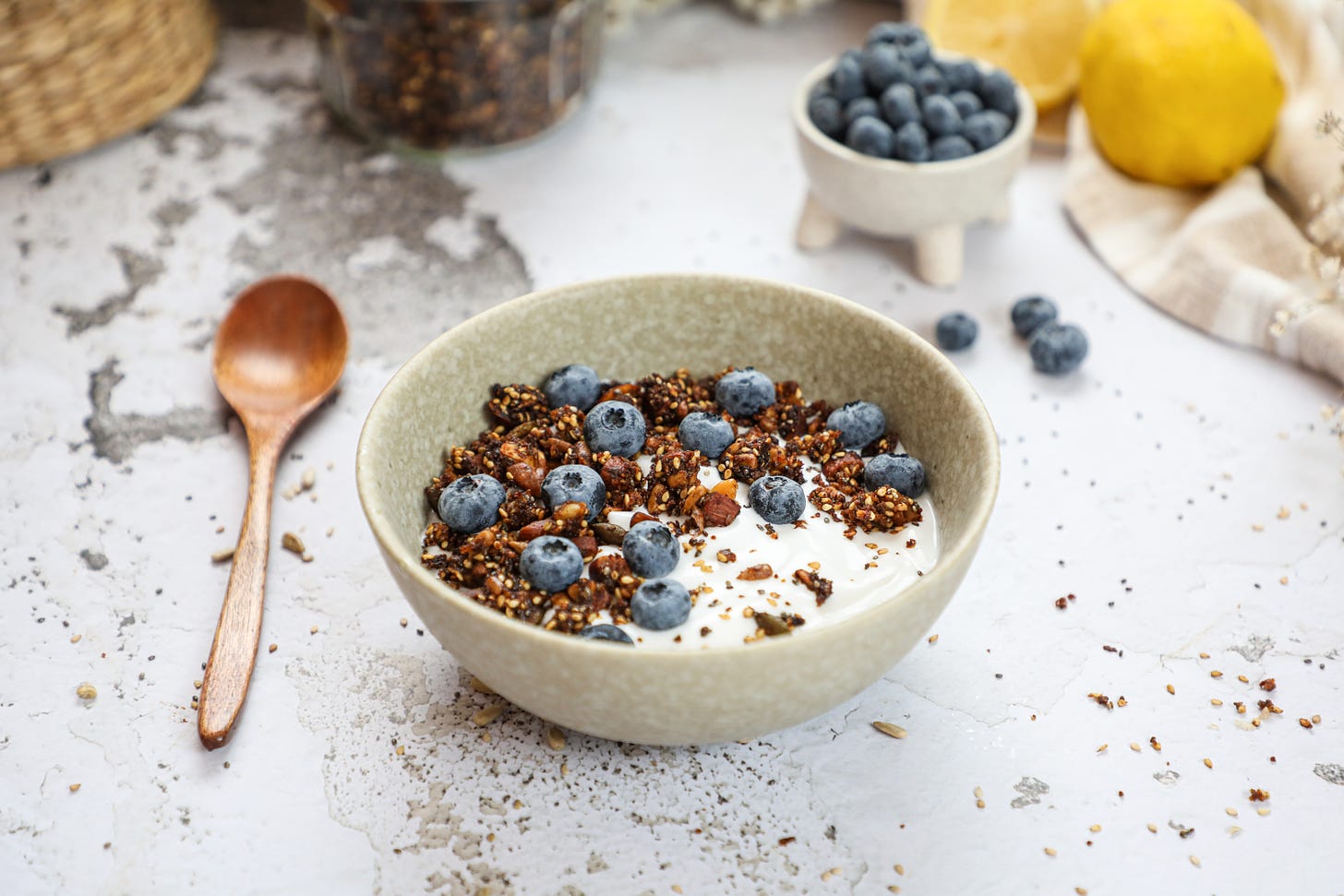 Bowl of yogurt with granola and blueberries on top.