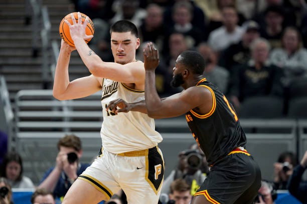 Zach Edey of the Purdue Boilermakers handles the ball while being guarded by Jonathan Aku of the Grambling State Tigers in the second half during the...