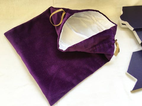 The purple bag from the Mystery of Easter sit open with its white interior fabric revealed.