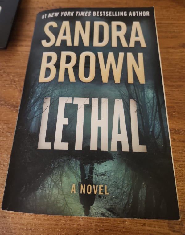 Sandra Brown's Book with dark green forest background Sandra Brown's Book with dark green forest background