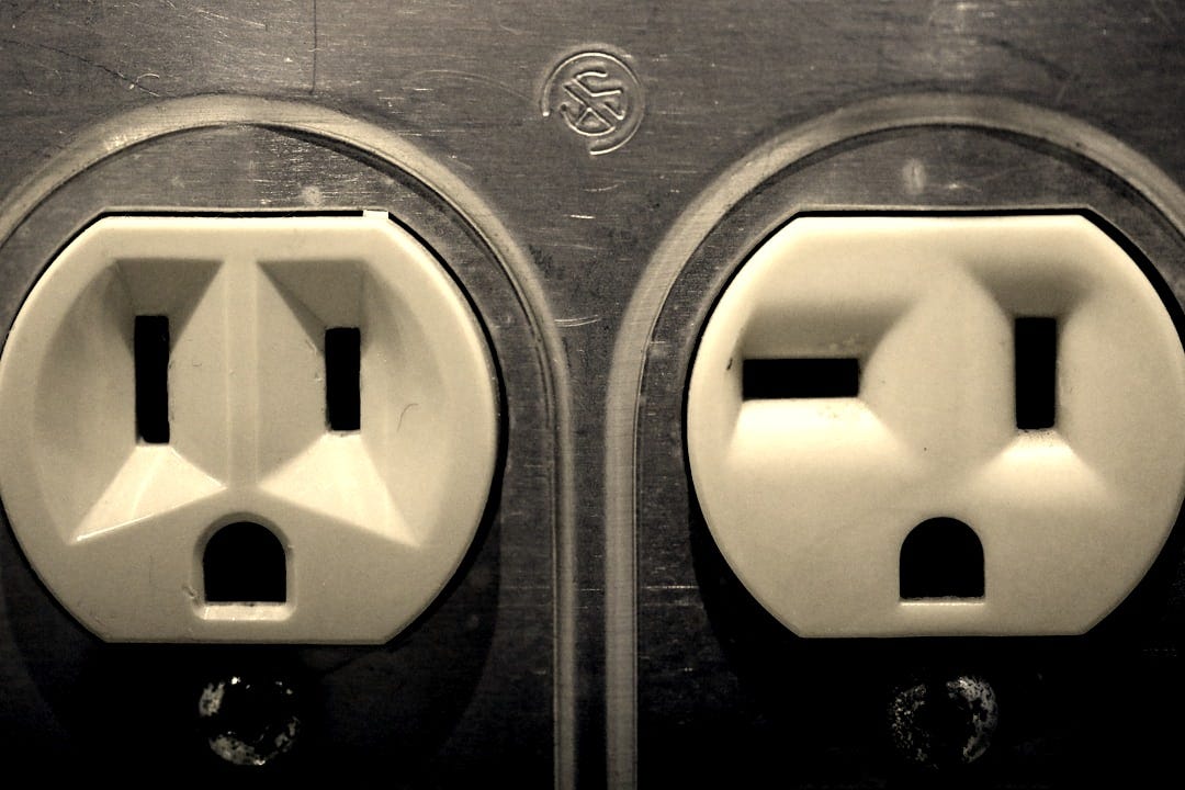 a couple of white electrical outlets sitting next to each other