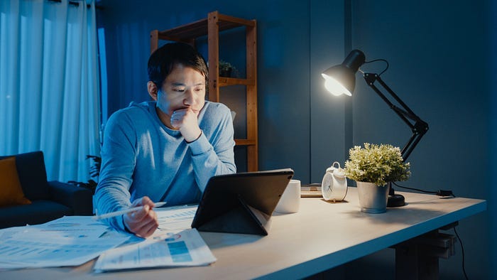 A man working in front of a tablet. A man working in front of a tablet.