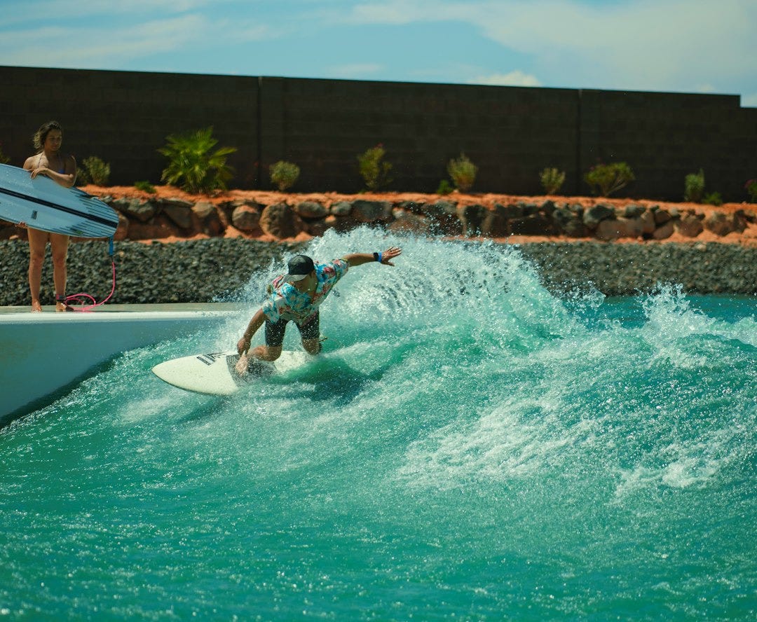 a man riding a wave on top of a surfboard