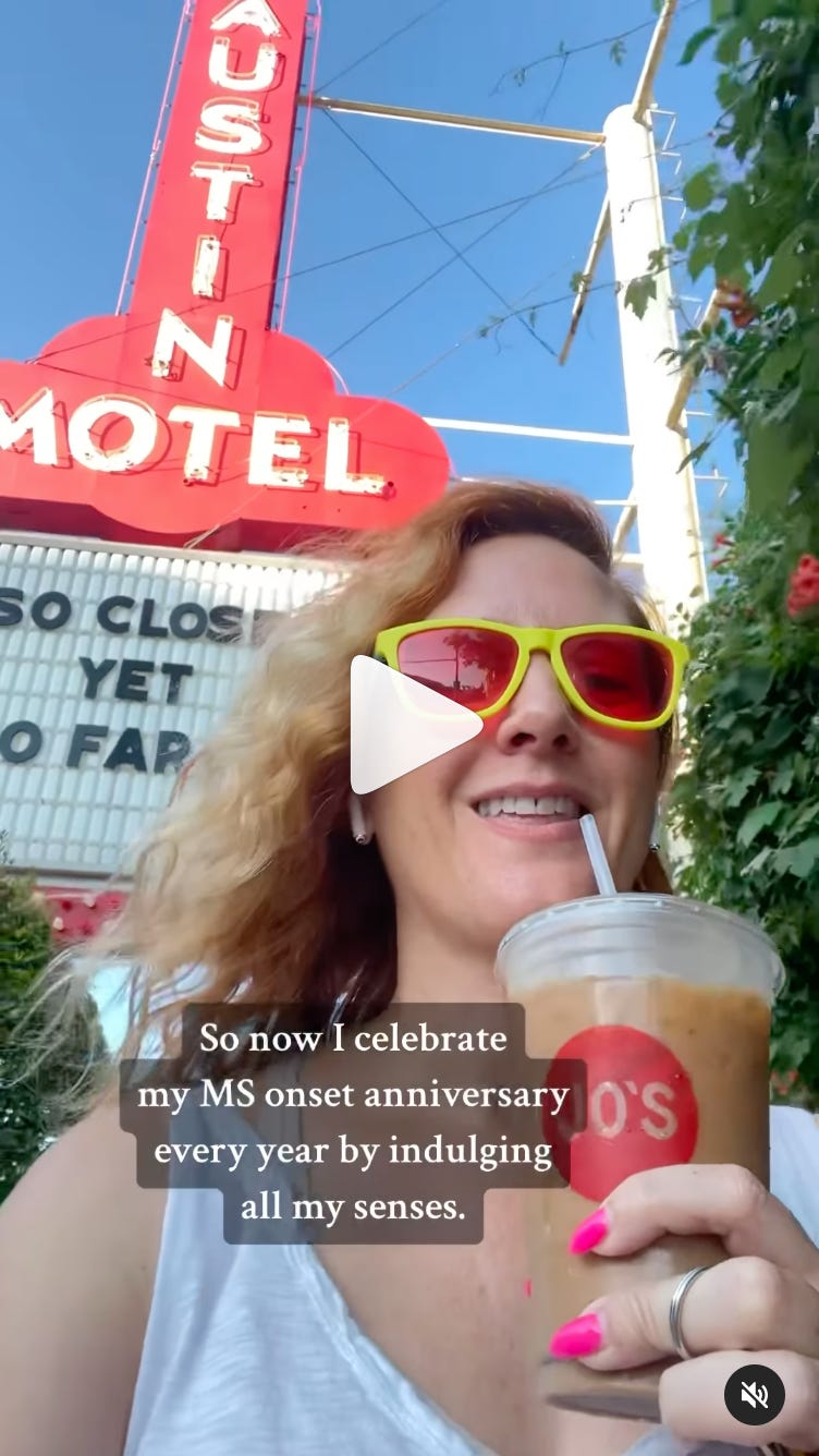 A white woman with blonde/red hair and yellow sunglasses smiles while drinking an iced coffee with the Austin Motel marquee behind her. There is a play button over the image - it links to a video.