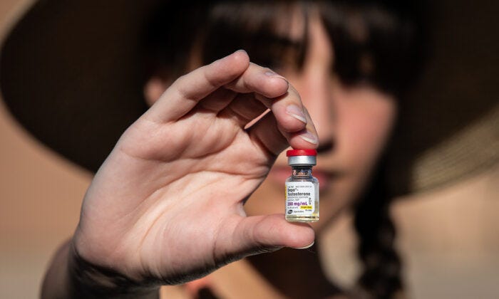Chloe Cole, an 18-year-old woman who regrets surgically removing her breasts, holds testosterone medication used for transgender patients in Northern California on Aug. 26, 2022. (John Fredricks/The Epoch Times)