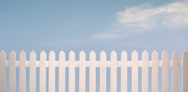 a white picket fence against a sky background
