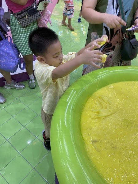 Little Rafa playing with slime at Gootopia