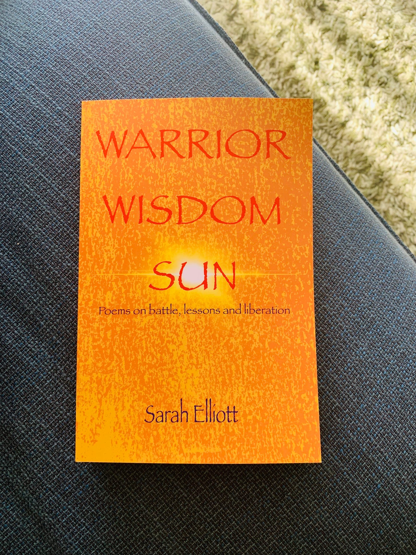 Book entitled Warrior Wisdom Sun placed on sofa