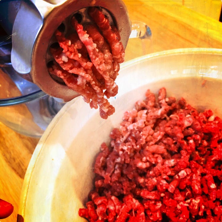 Shin of beef being minced into a bowl.