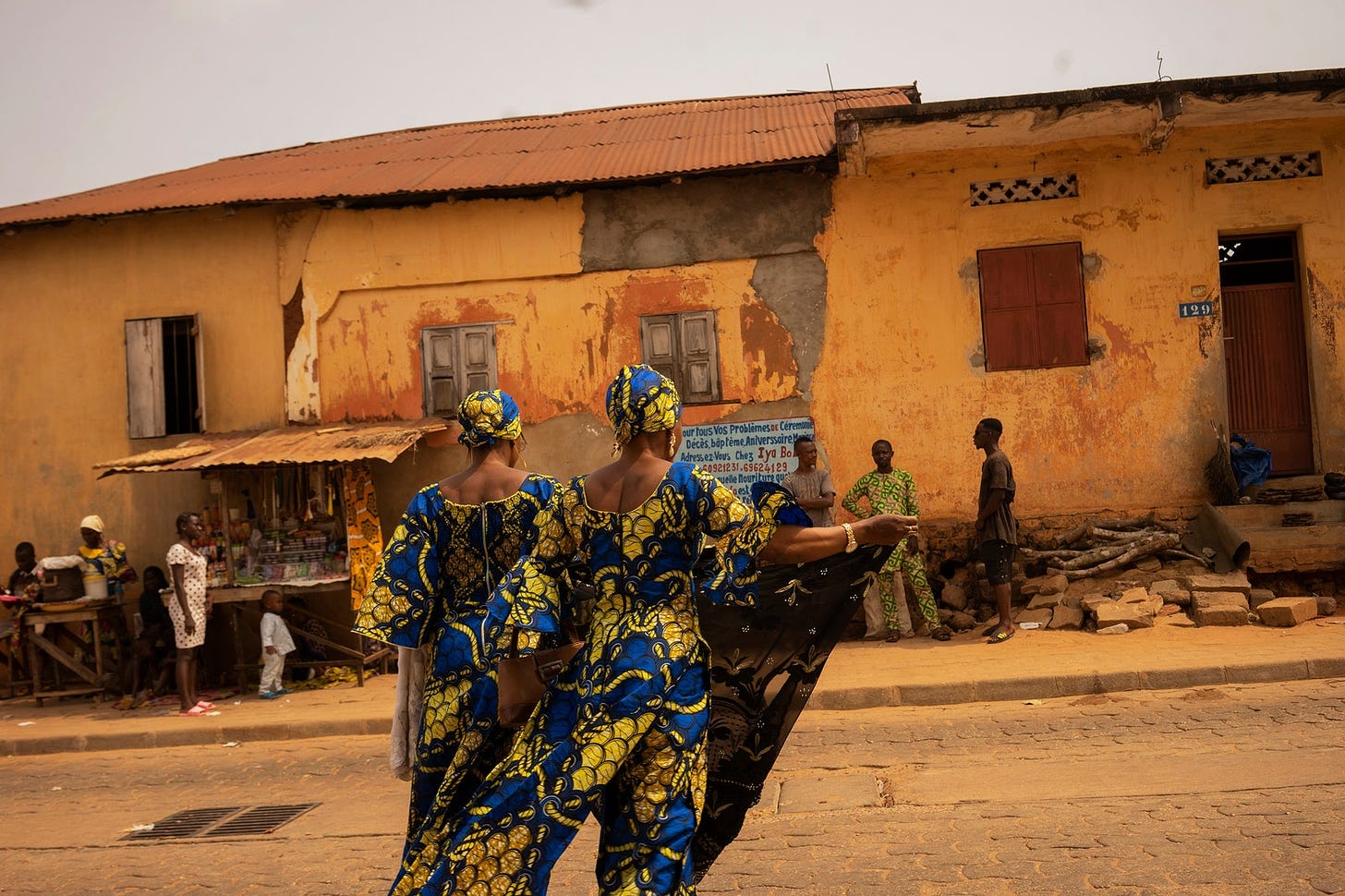 Two African women crossing a street.