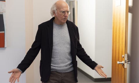 Larry David of Curb Your Enthusiasm wearing a crew-neck jumper and blazer