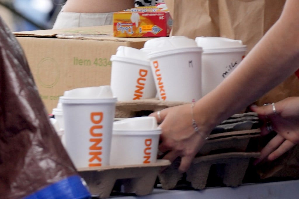 A tray of Dunkin' branded coffee cups