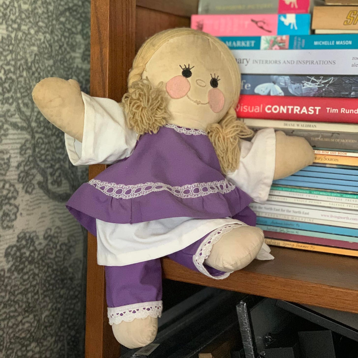 handmade rag doll in purple and white clothing