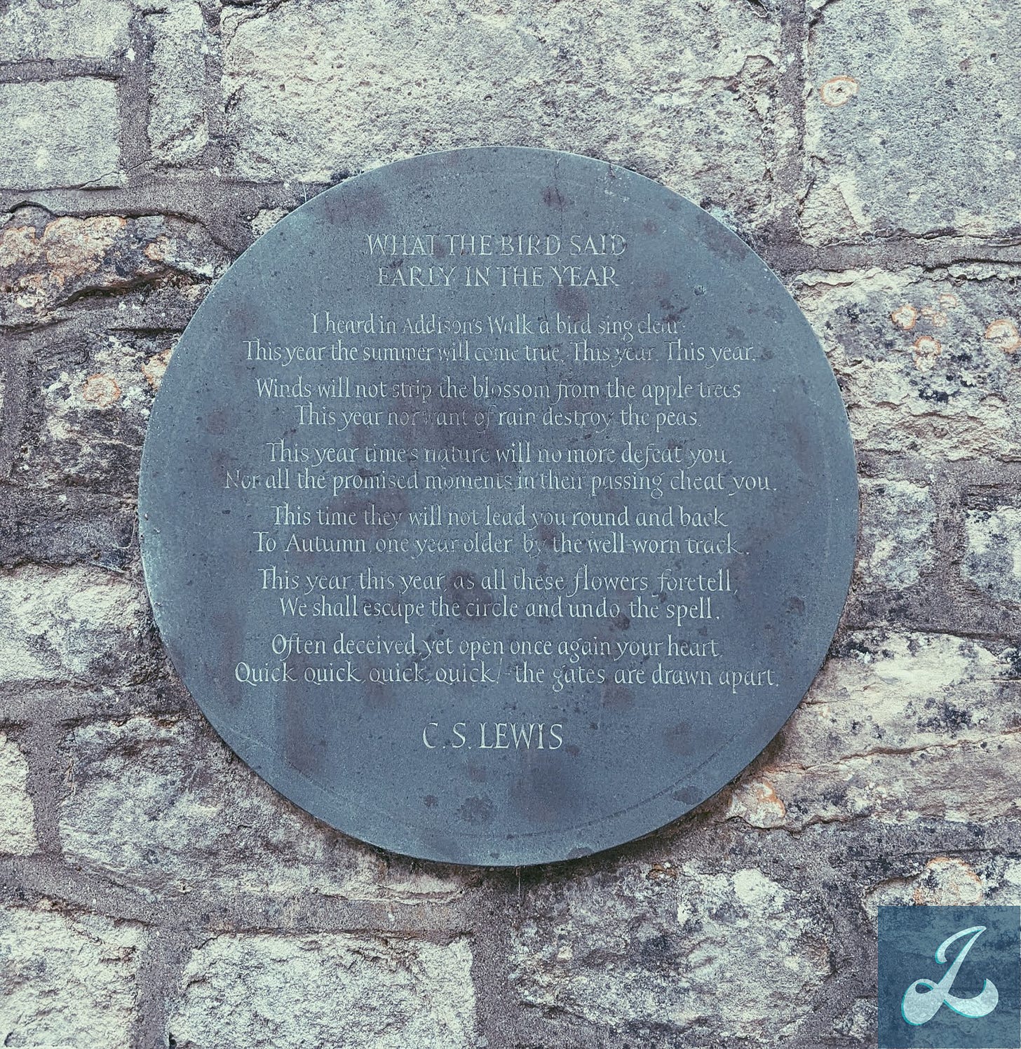 A worn, slightly rusted circular metal plaque posted on a stone wall that contains the text for the poem "What the Bird Said Early in the Year" by C. S. Lewis.