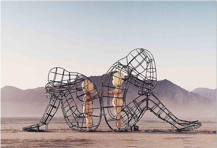 Ukrainian artist Alexander Milov’s piece presents a  sculpture that features two wire adult figures sitting back-to-back. Inside their frames stand two children who are reaching out to one another.