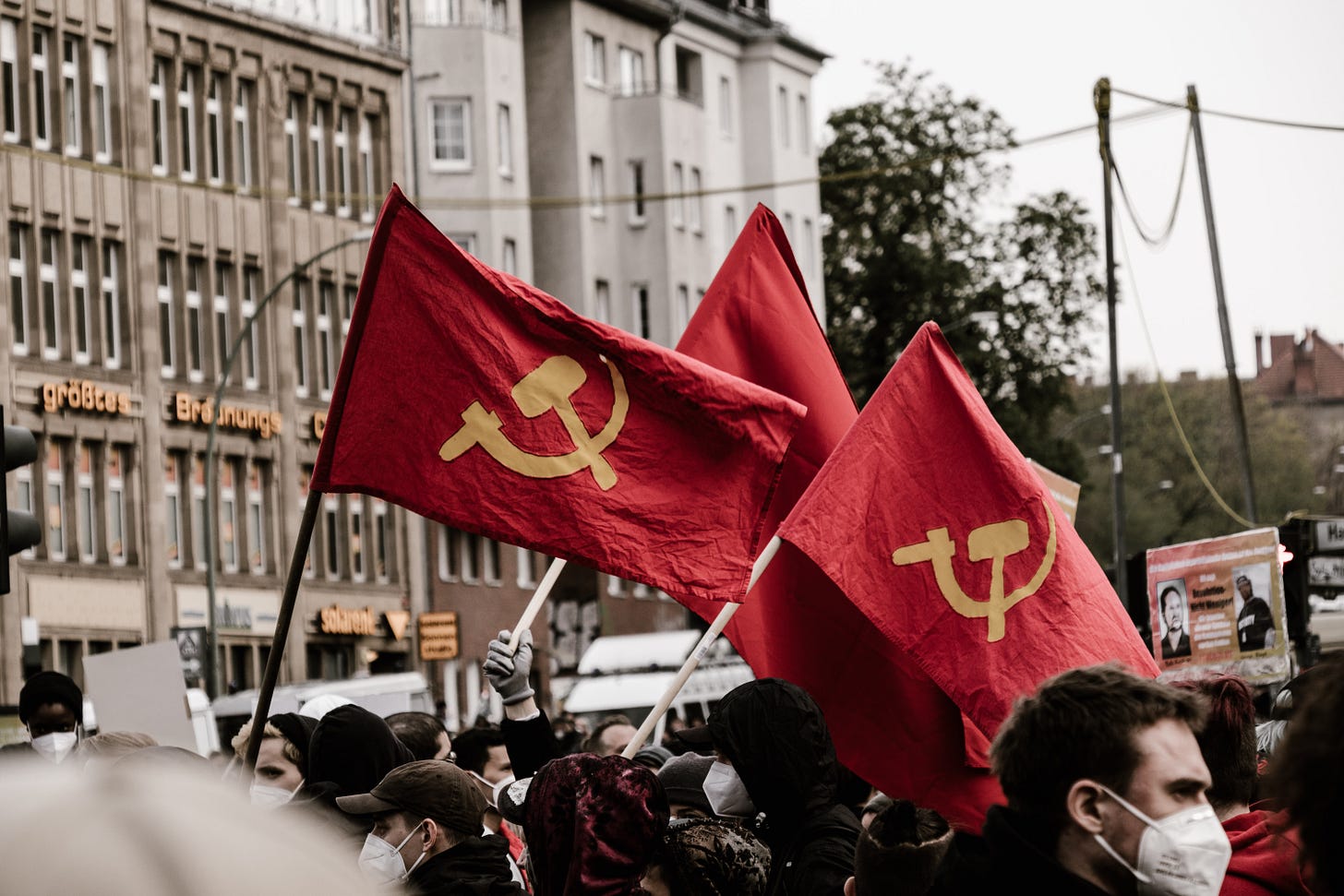 An image of hammer and cycle flags at a workers' day rally in Berlin