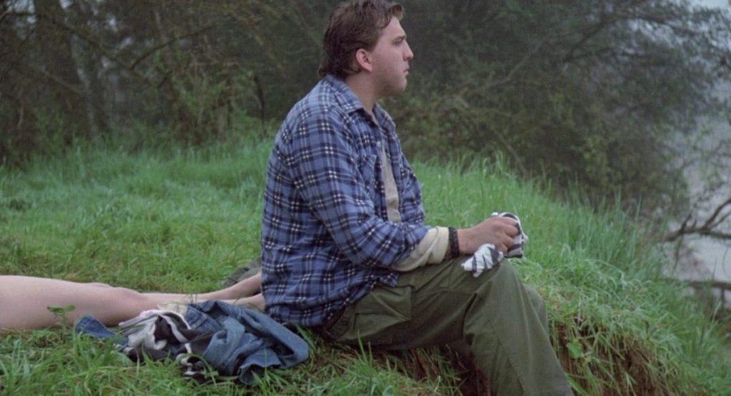 Daniel Roebuck, as Sampson, sits calmly beside the body of his girlfriend. 