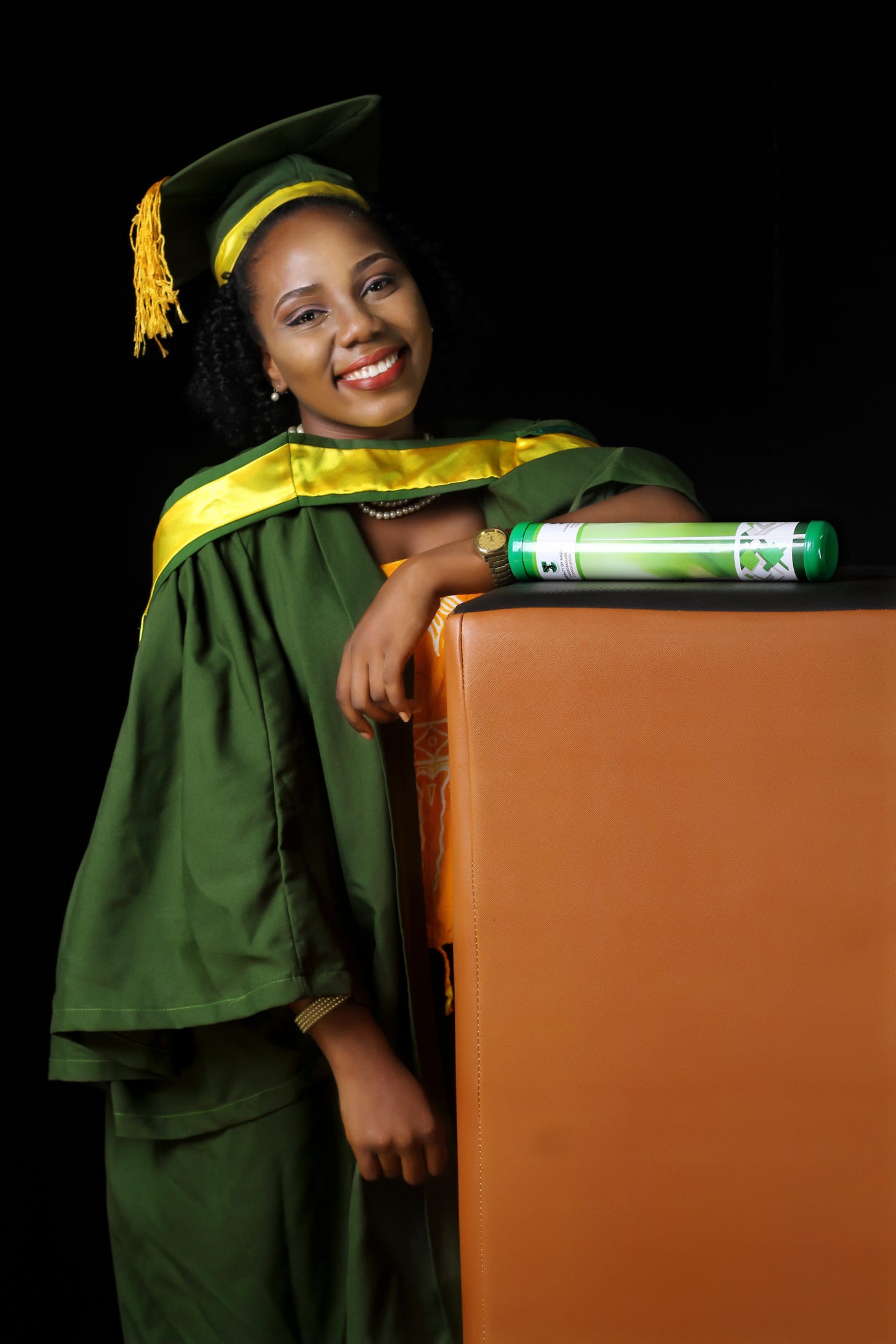 Studio photograph of a lady in UNN convocation gown