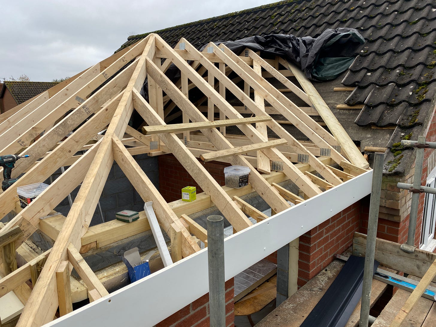 roof trusses now being positioned into the existing roof