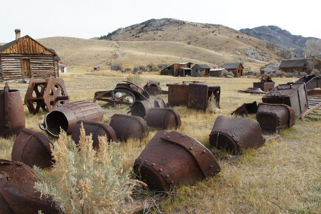Old iron mining carts and other equipment rust in place.