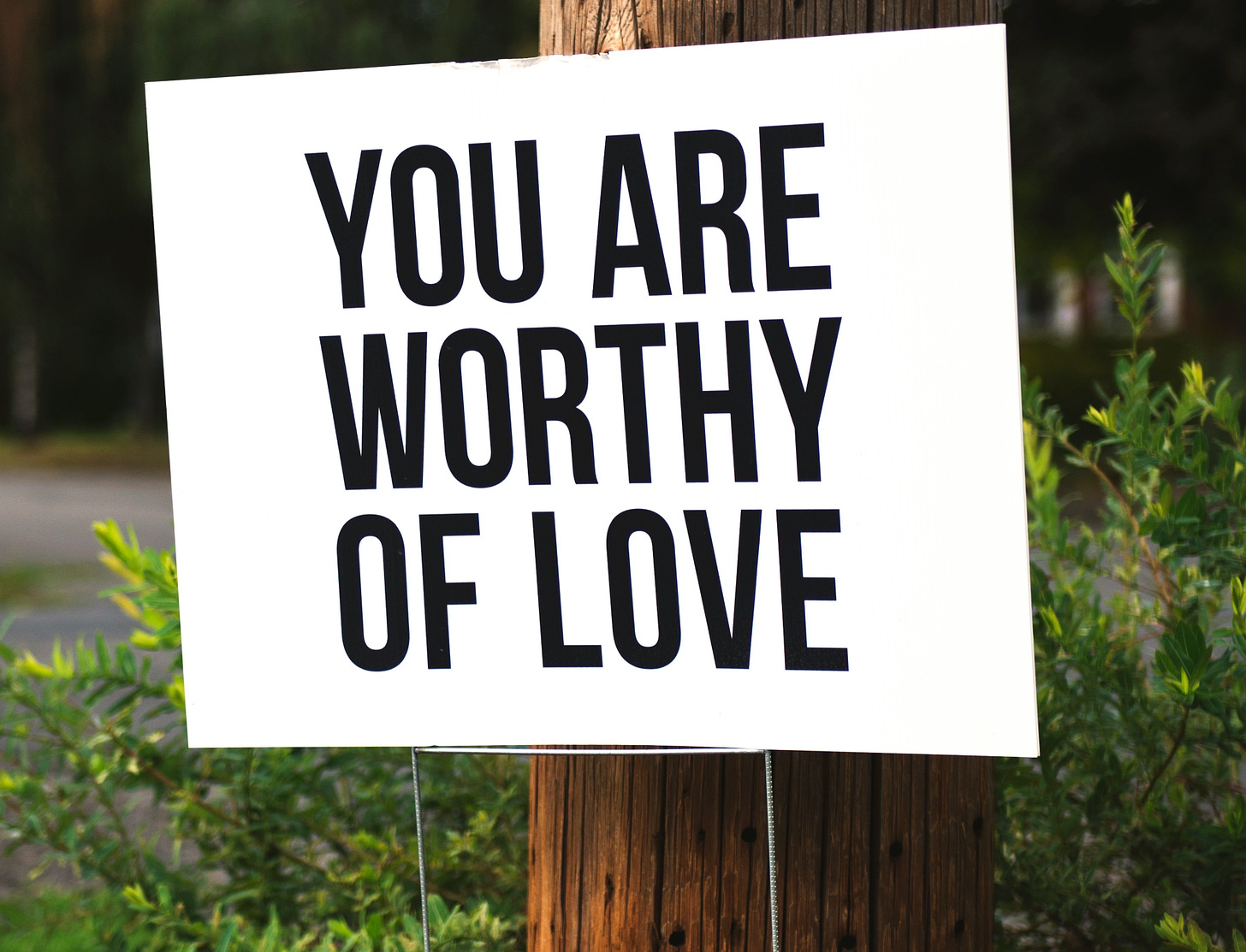 Sign reading "You are worthy of love"