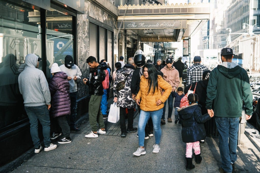 Migrants seeking asylum in the United States gather outside of the Roosevelt Hotel, which doubles as a shelter for families and the main processing center in New York City. 
