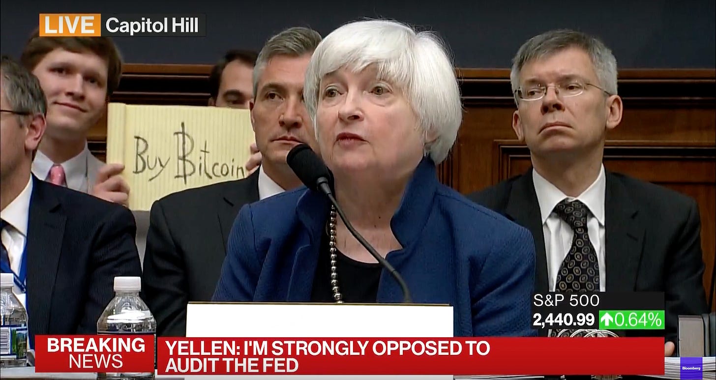 Buy Bitcoin' Sign Raised as Fed Chair Janet Yellen Testifies Before  Congress - CoinDesk