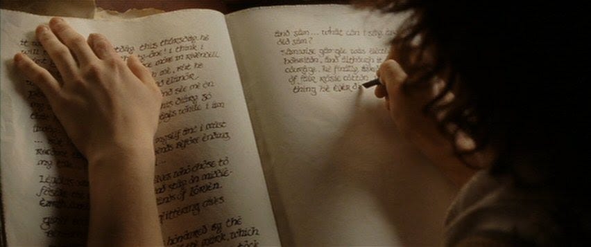 Frodo writing in the Red Book