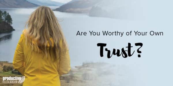 A woman with long blonde hair and a yellow rain jacket looks away from the camera, out at a lake. Text Overlay: Are You Worthy of Your Own Trust?