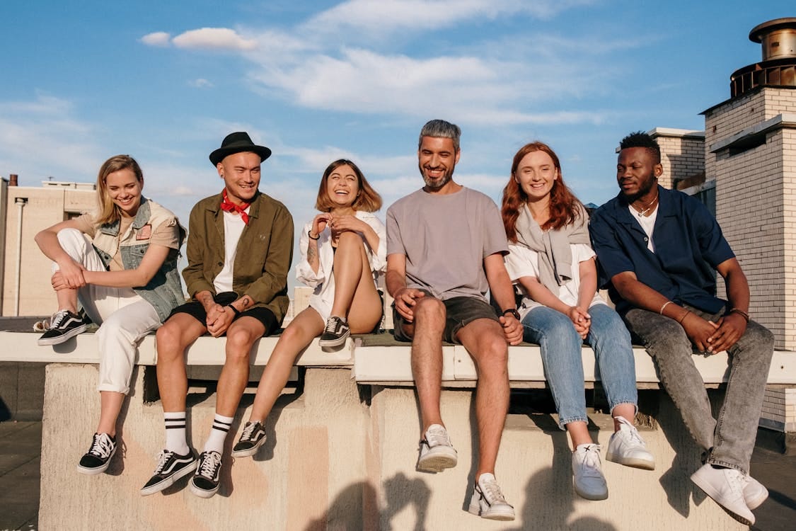 Free Group of People Sitting on Concrete Bench Stock Photo Free Group of People Sitting on Concrete Bench Stock Photo