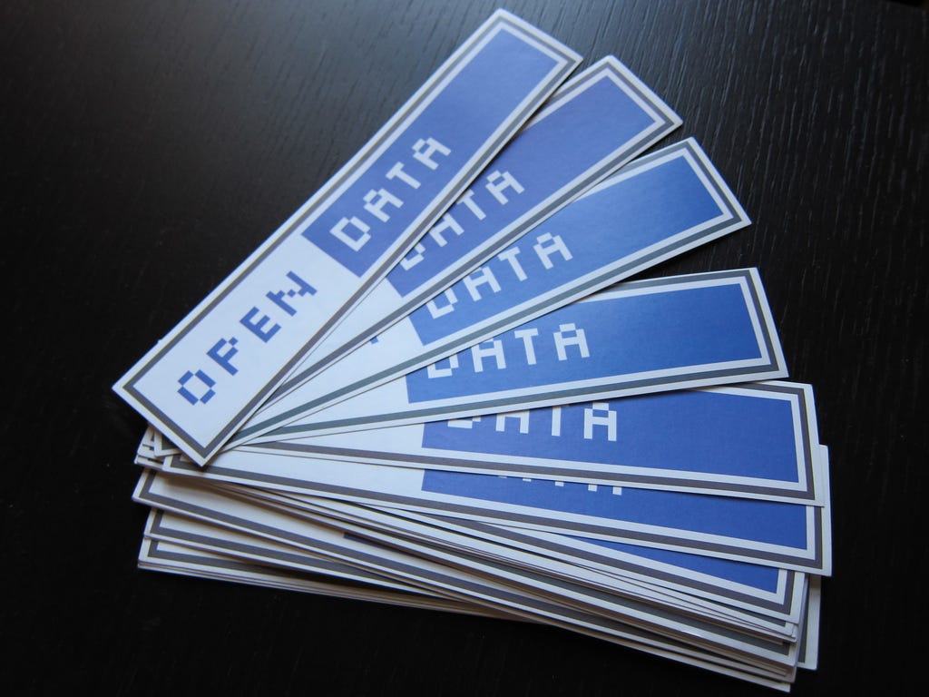 blue and white stickers on a table saying 'open data'