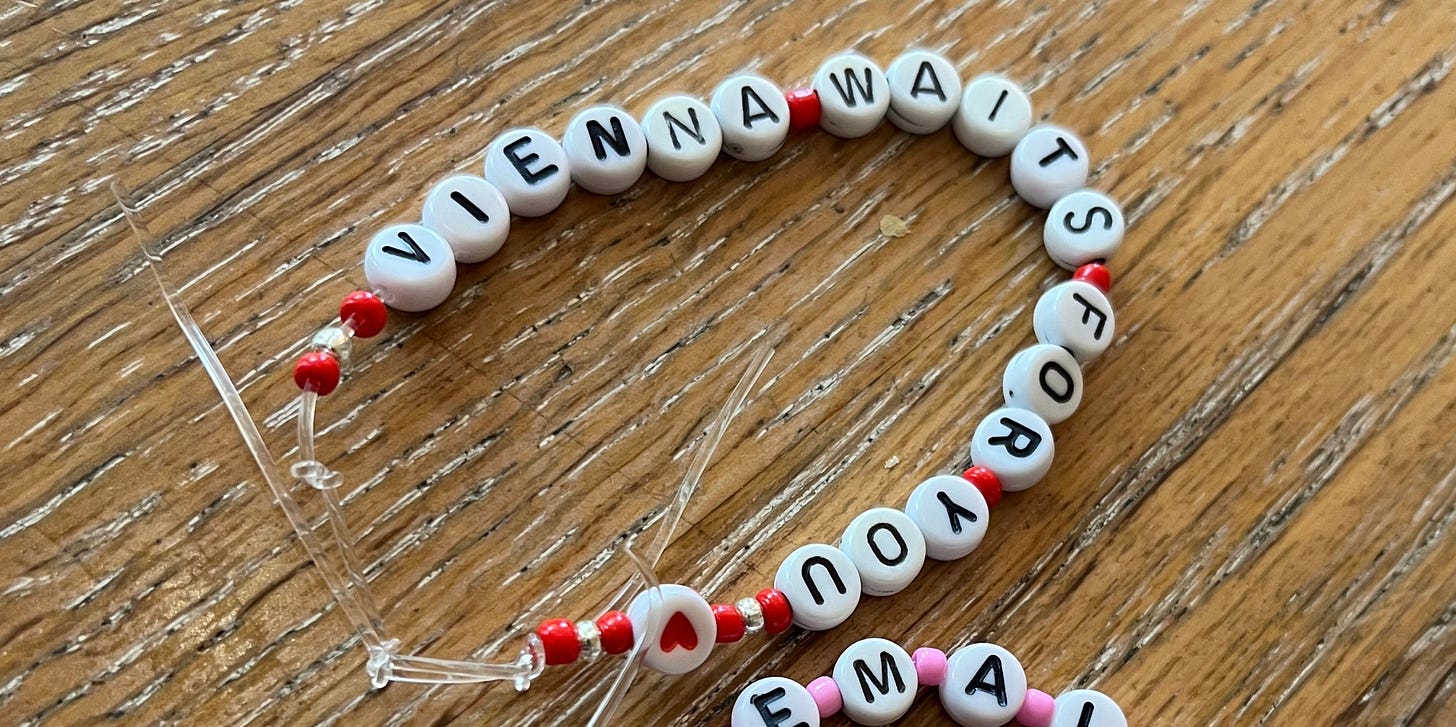 A homemade lettered friendship bracelet with the Billy Joel lyric ‘Vienna waits for you’ and beads in the colours of the Austrian flag.