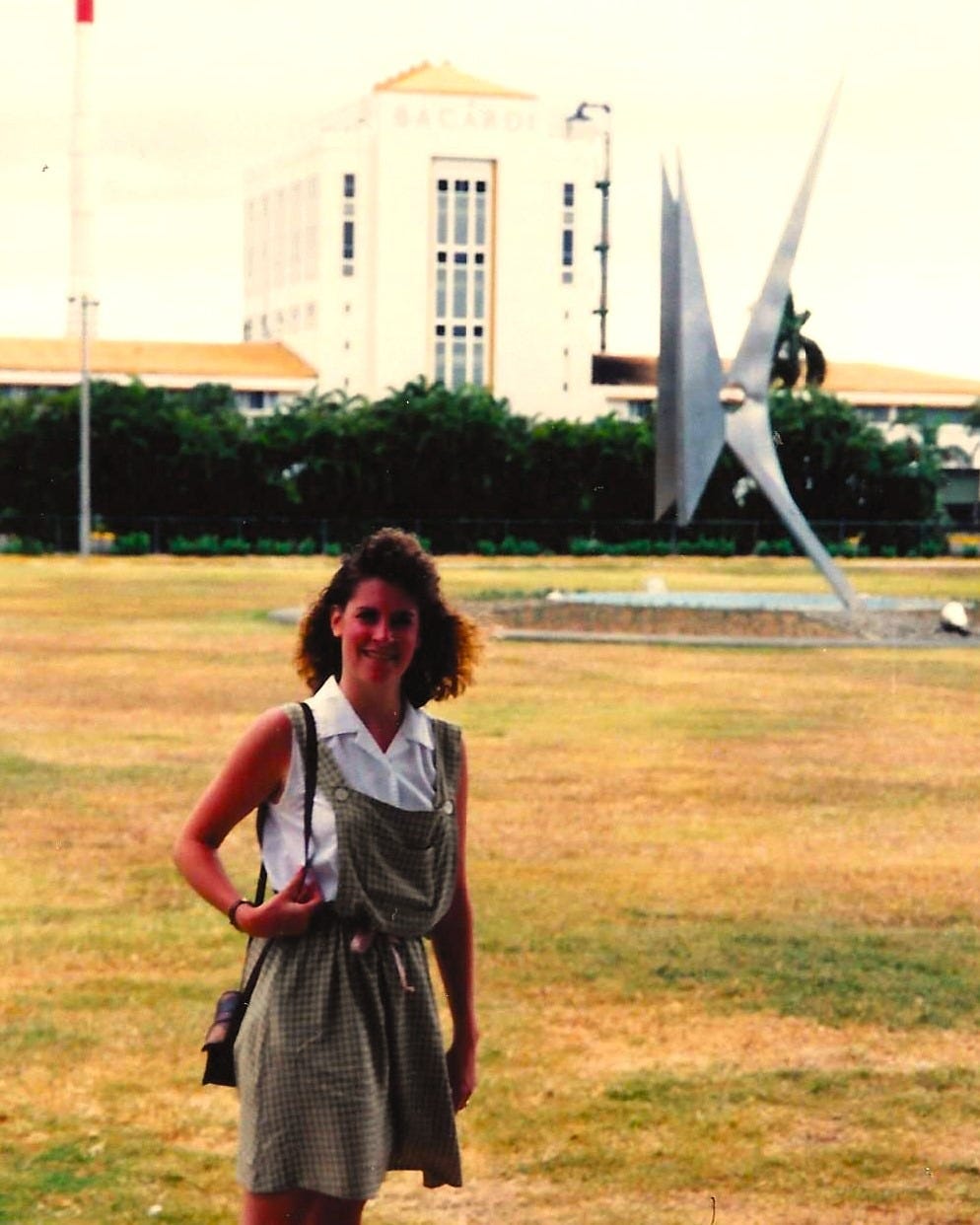 20-something woman standing in front of the Bacardi rum factory