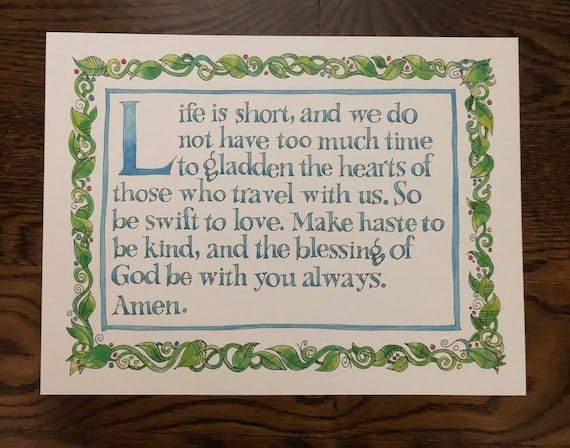 A card bearing the text, "Life is short and we do not have much time to gladden the hearts of those who travel with us. So be swift to love. Make haste to be kind, and the blessing of God be with you always. Amen"