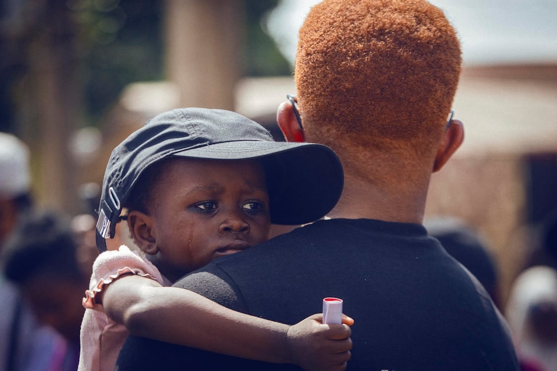 Free Man Comforting Crying Child Stock Photo