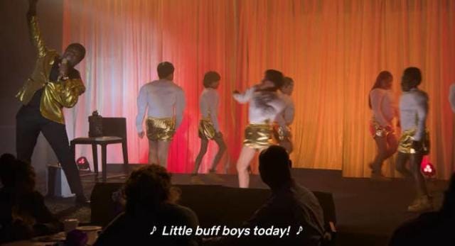 Still from I Think You Should Leave Season 2 "Little Buff Boys" sketch. Boys in goose suits circle the stage while the captioning beneath reads "Little buff boys today!"