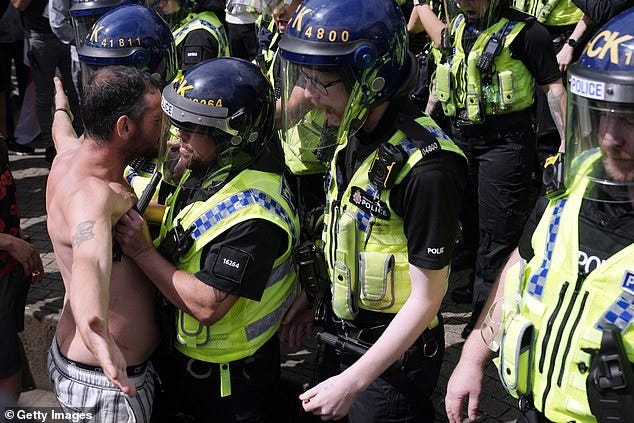 Police clash with right wing protesters in Piccadilly Gardens, Manchester, on August 3