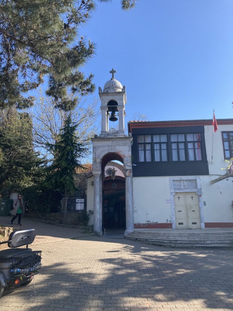 Bell tower and white stone entrance to Aya Yorgi on Buyukada Island.