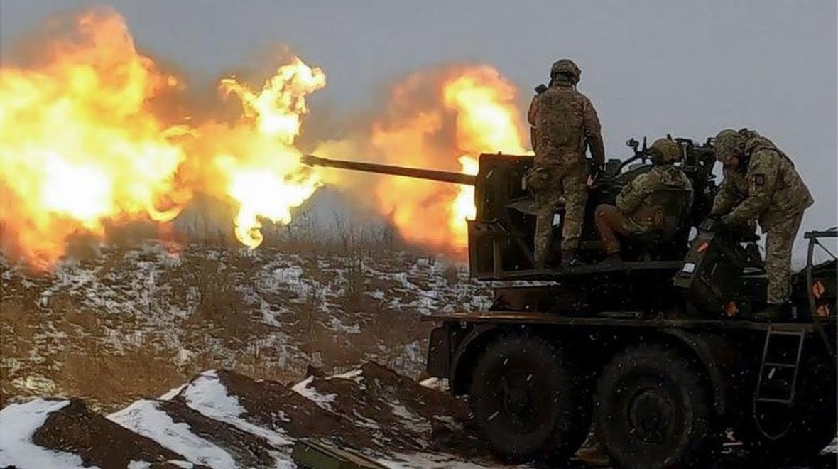 Ukrainian soldiers fire an anti-aircraft gun