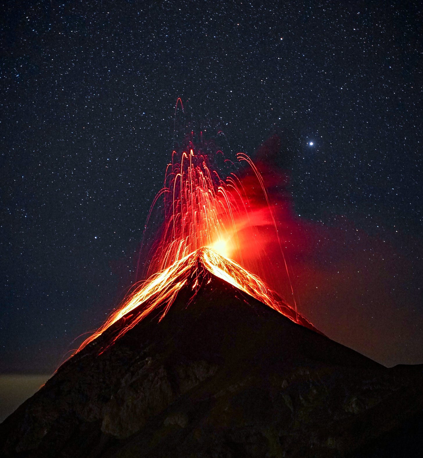 Volcano on a clear night with stars