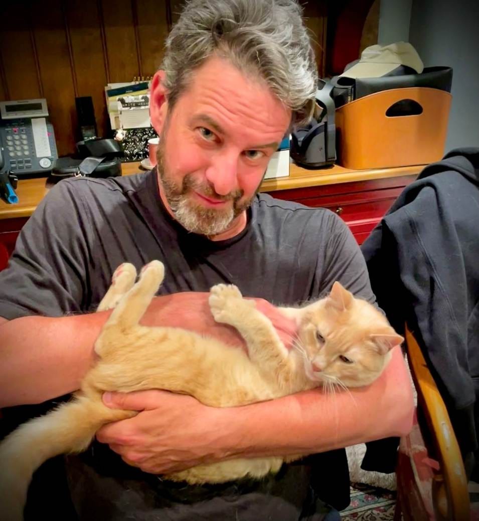 A person holding a cat

AI-generated content may be incorrect.