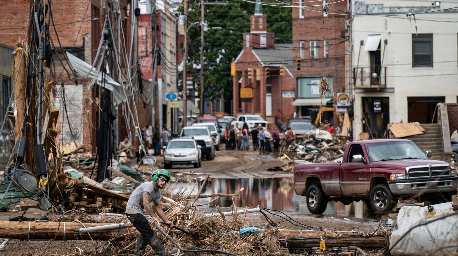 Workers, community members, and business owners clean up debris in the aftermath of Hurricane Helene on Monday in Marshall, N.C. Credit: Jabin Botsford/The Washington Post via Getty Images