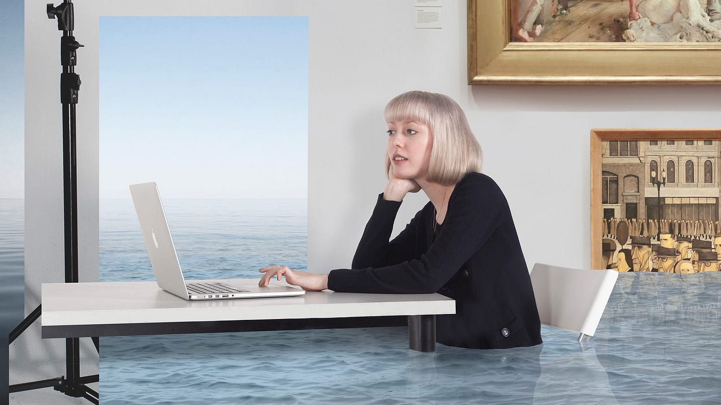 A woman at a desk using her laptop while the room fills with water A woman at a desk using her laptop while the room fills with water