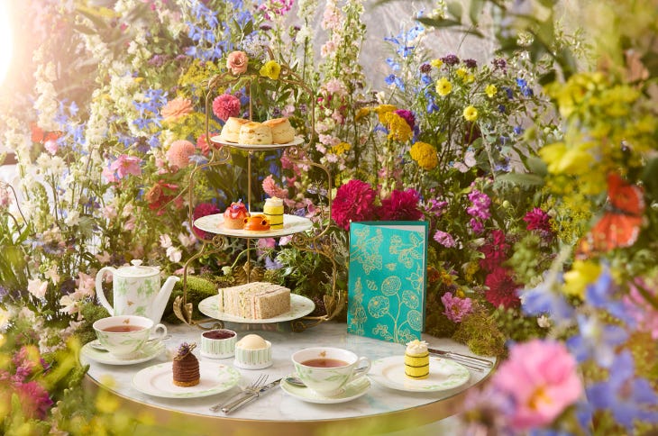 An afternoon tea stand against a floral backdrop