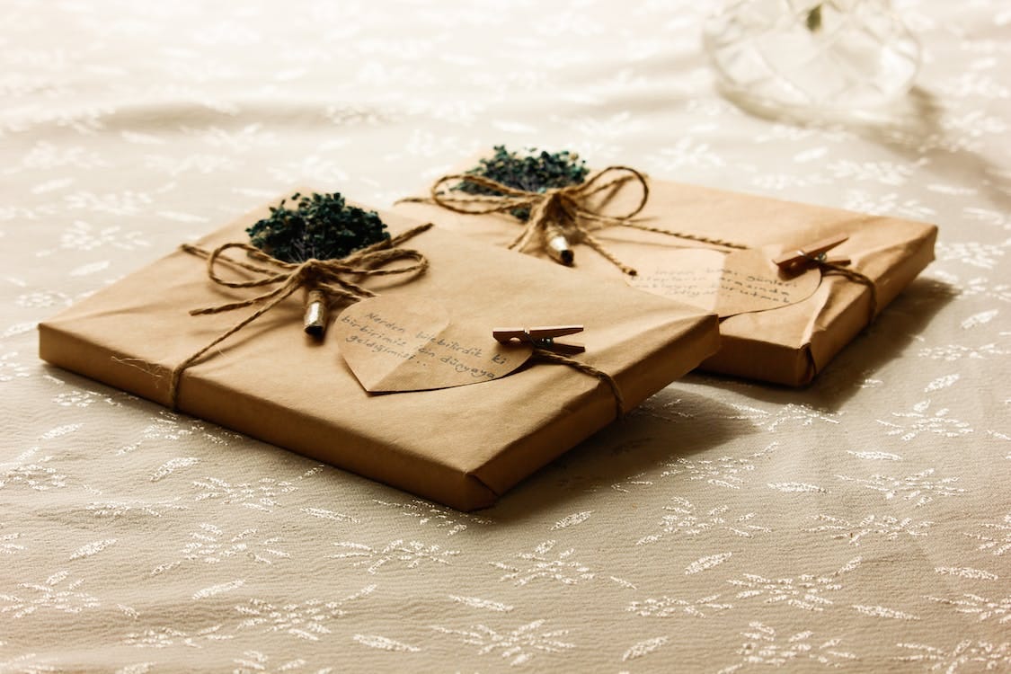 Free Presents Wrapped in Brown Paper with Heart Shape Cards Stock Photo
